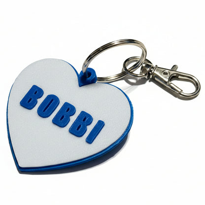 Heart-shaped keychain name tag with 'BOBBI' on a white background