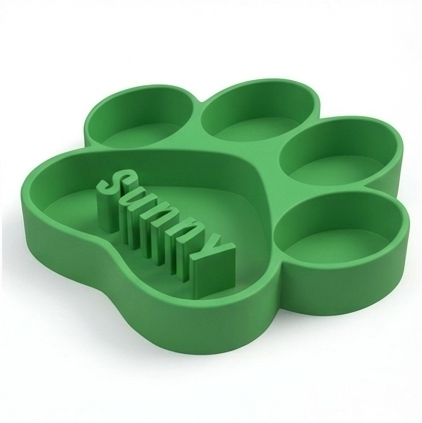 Green paw-shaped dog bowl with 'Sunny' text on a white background