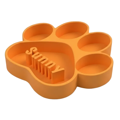Orange paw-shaped dog bowl with 'Sunny' text on a white background