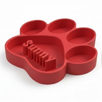 Red paw-shaped dog bowl with 'Sunny' text on a white background
