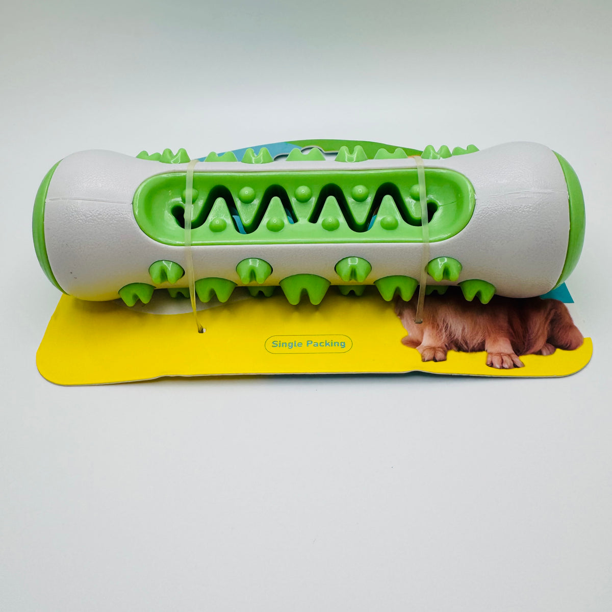 Green Molar Chew & Dental Toy for dogs with molar bumps, resting on its card