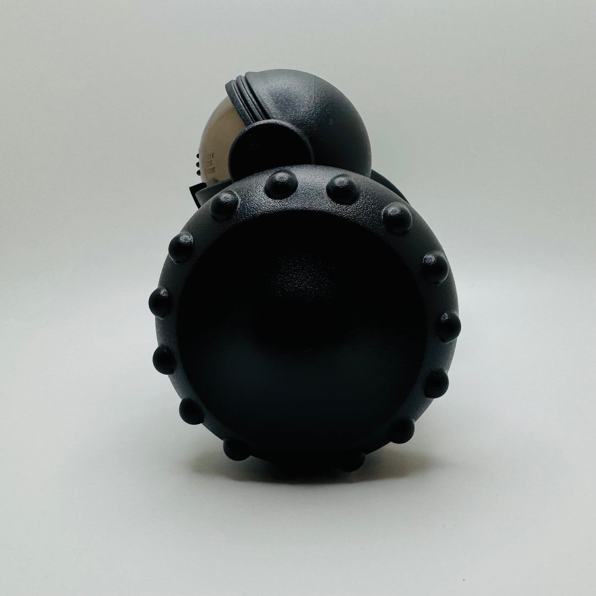 Black Robot Slow Feeder & Treat Dispenser Toy, side view of the spiked wheel