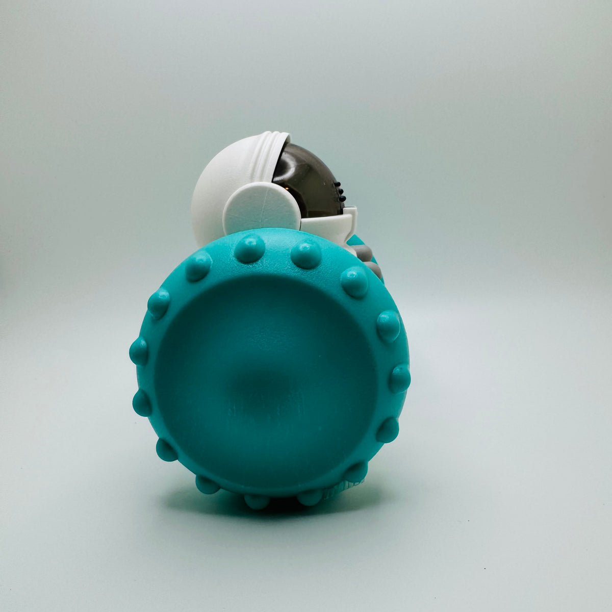 Teal Robot Slow Feeder & Treat Dispenser Toy, side view of the spiked wheel