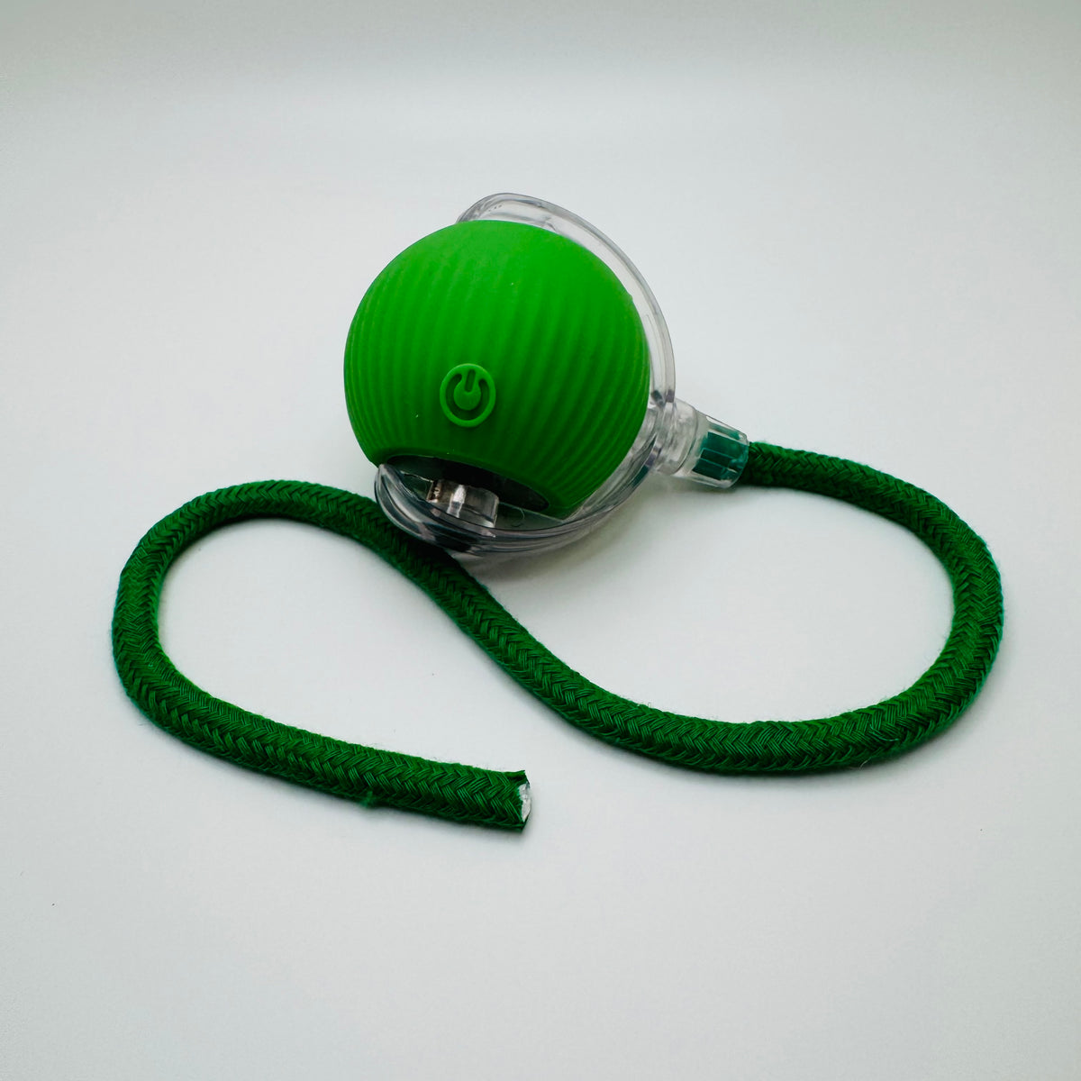 Green Vibrating Bouncing Ball Toy with a dark green rope tail