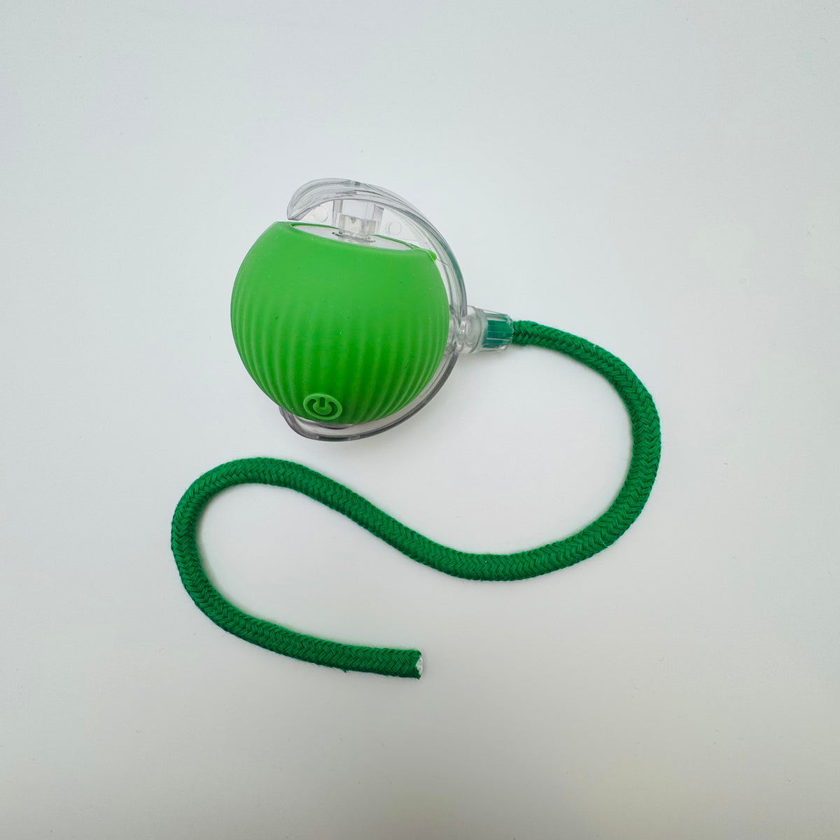 Green Vibrating Bouncing Ball Toy with a dark green rope tail, top view