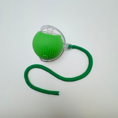 Green Vibrating Bouncing Ball Toy with a dark green rope tail, top view