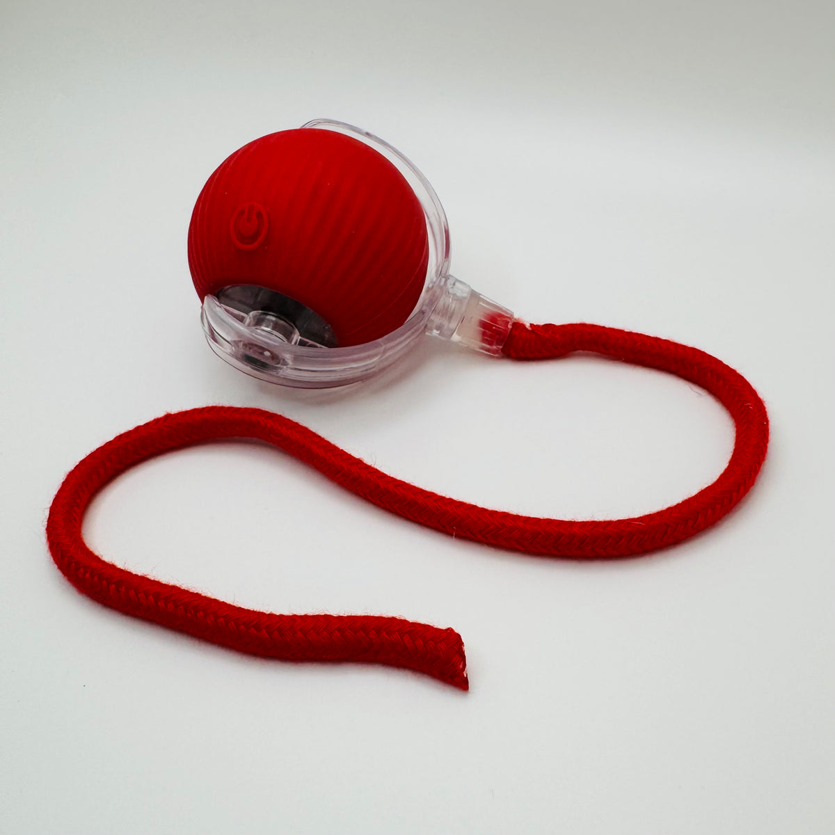 Red Vibrating Bouncing Ball Toy with a red rope tail, angled view