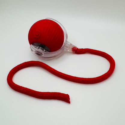 Red Vibrating Bouncing Ball Toy with a red rope tail, angled view