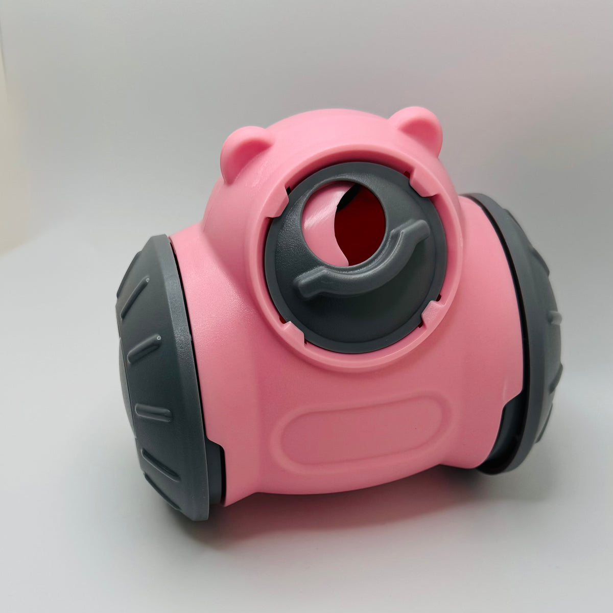 Pink Bear Slow Feeder & Treat Dispensing Toy for dogs, front view with grey wheels and rotary hole