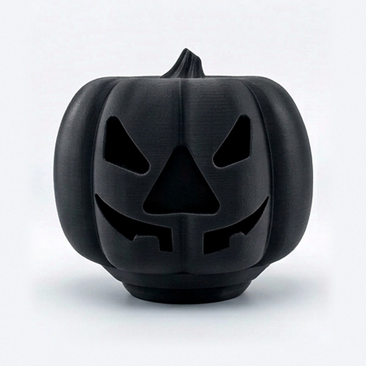Black pumpkin treat dispenser for dogs and cats with carved jack-o'-lantern face