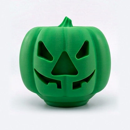 Green pumpkin treat dispenser for dogs and cats with carved jack-o'-lantern face