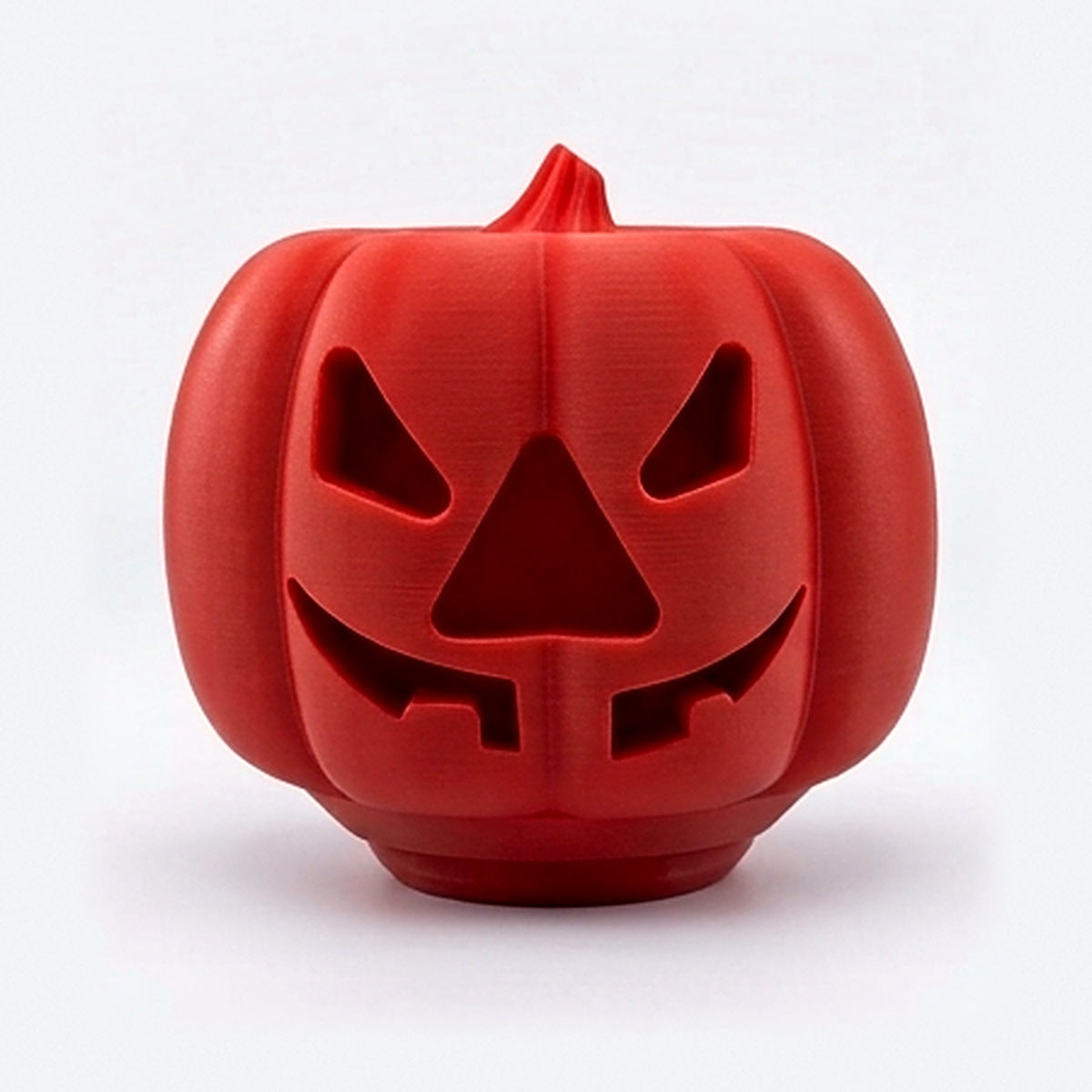 Red pumpkin treat dispenser for dogs and cats with carved jack-o'-lantern face
