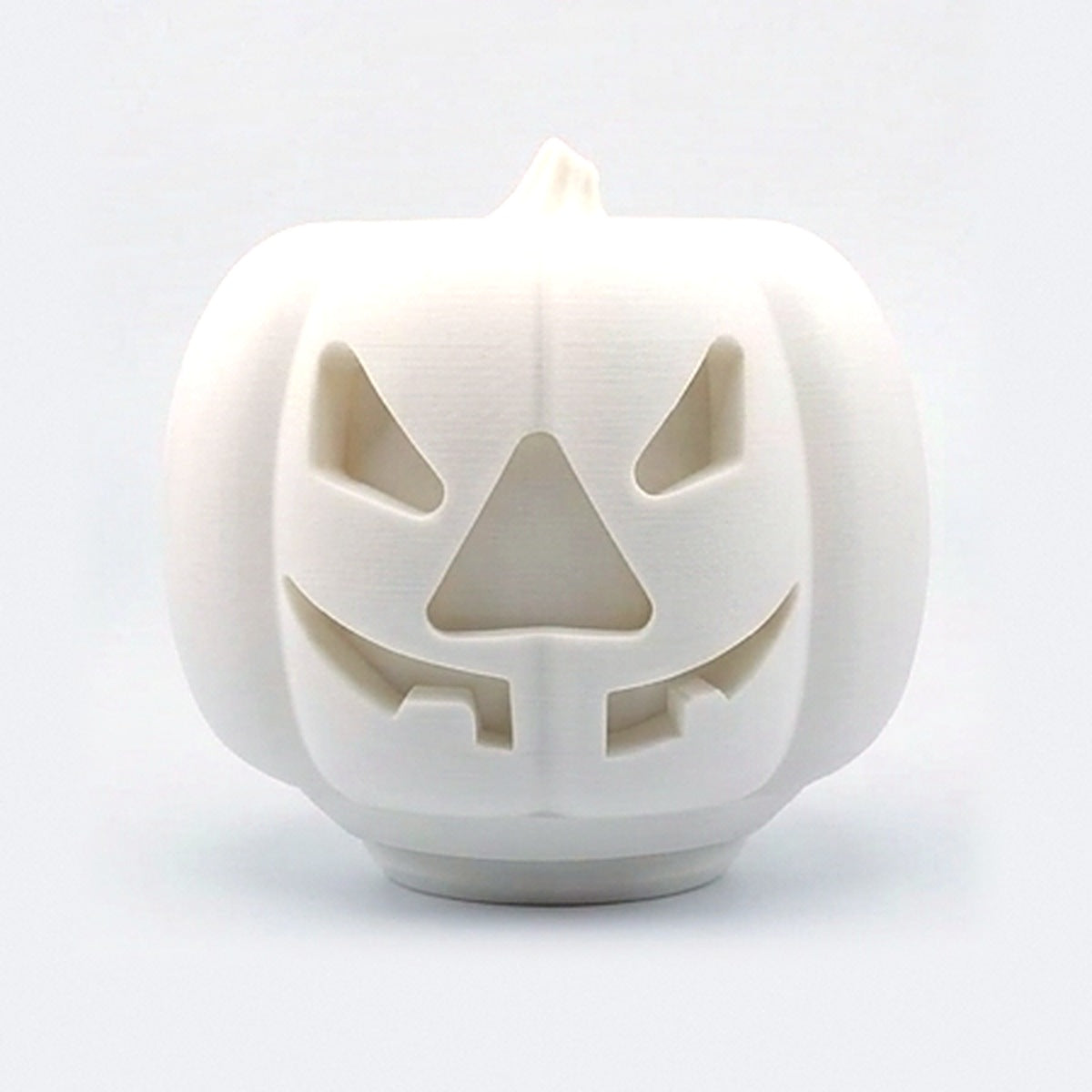 White pumpkin treat dispenser for dogs and cats with carved jack-o'-lantern face