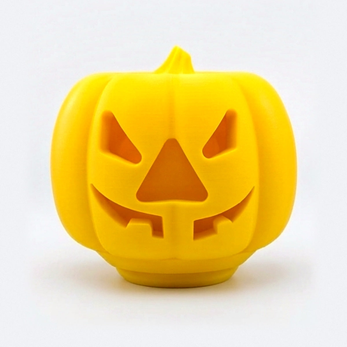 Yellow pumpkin treat dispenser for dogs and cats with carved jack-o'-lantern face