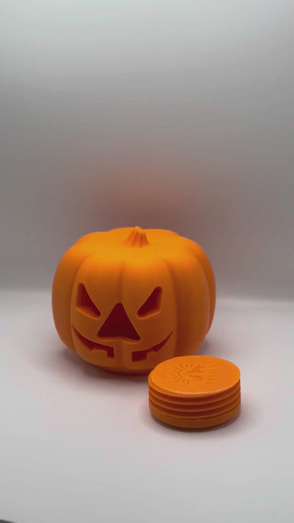 Hands unscrewing the threaded bottom plug of the pumpkin treat dispenser to fill it