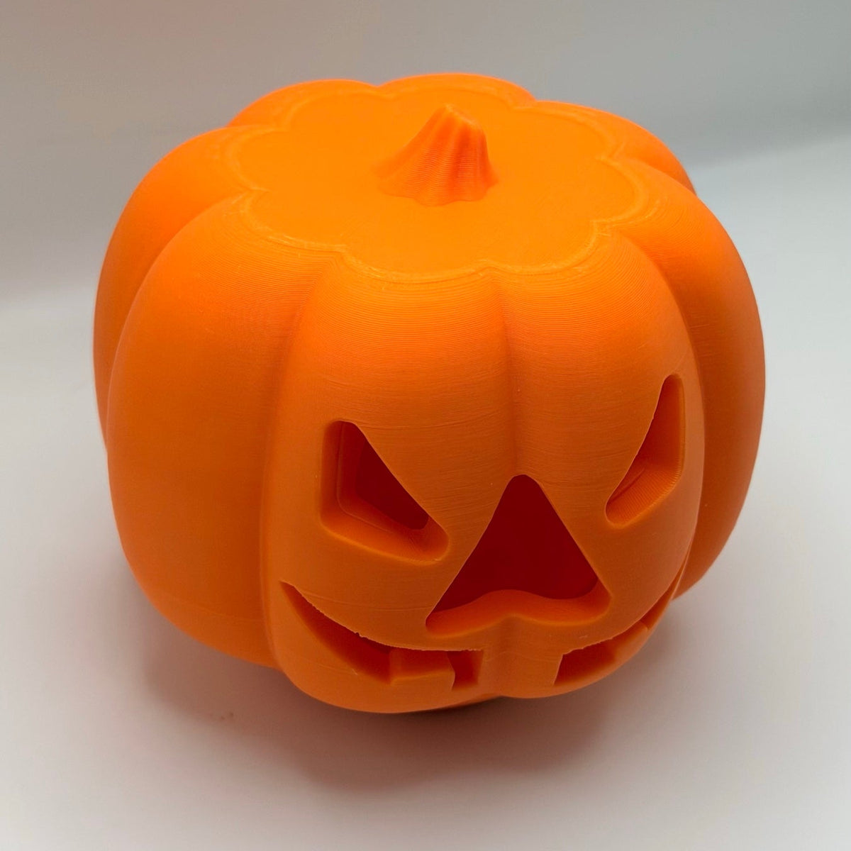 Orange pumpkin treat dispenser for dogs and cats, 3/4 view