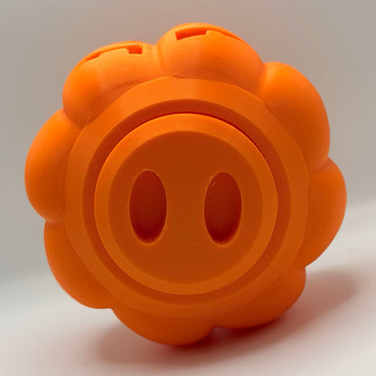 Orange pumpkin treat dispenser for dogs and cats, bottom view showing the fill plug