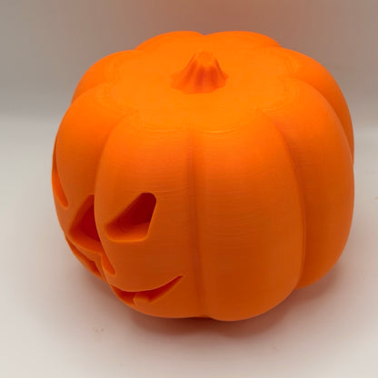 Orange pumpkin treat dispenser for dogs and cats, side view